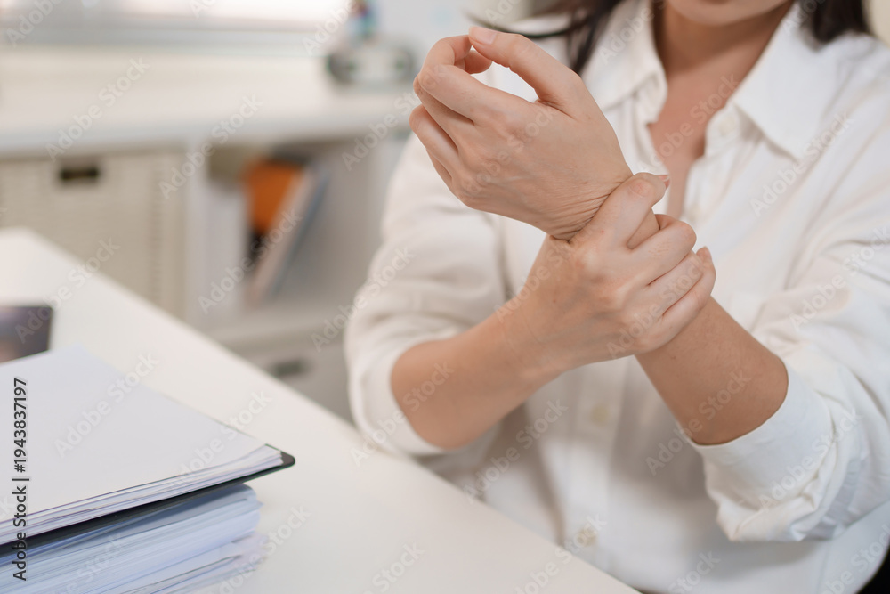Fototapeta premium Office worker experiencing wrist pain computer work and strain