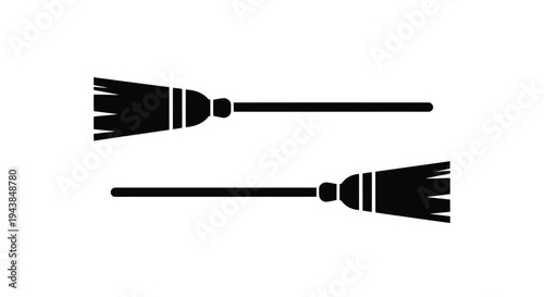 Two black silhouettes of brooms displayed in a simple minimalist style