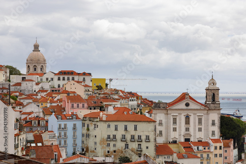 View over the red-tiled roofs and colourful facades of the old town of Lisbon, Portugal.