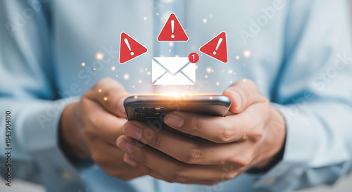 A close-up view of hands holding a smartphone, a digital envelope, accented by alert symbols, underscores the urgency and importance of digital communication and potential issues. 