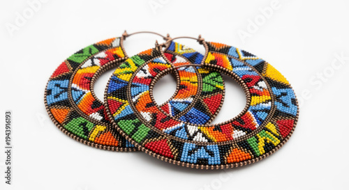 A pair of colorful, beaded hoop earrings with a mosaic pattern on a white background, showcasing vibrant African-inspired designs.