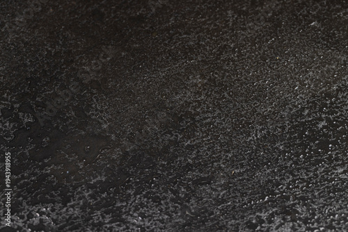 Bild auf Leinwand wet black uneven and embossed black slate for serving, covered with lots of wate