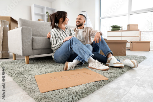 Young couple with doormat s...