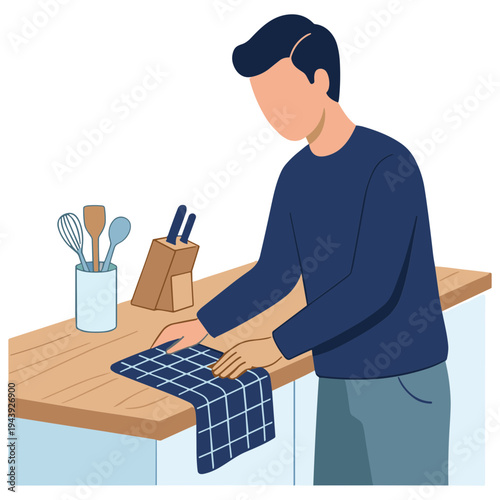 Man wiping down kitchen counter with towel beside utensils and knife block