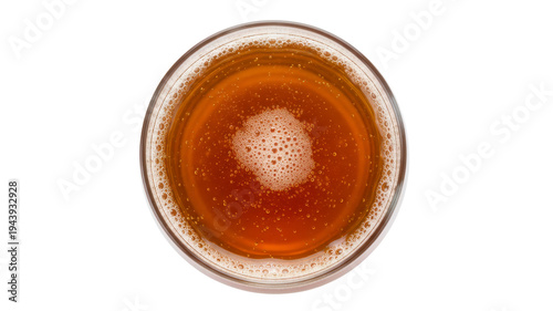 Top view of a glass of amber beer with foam