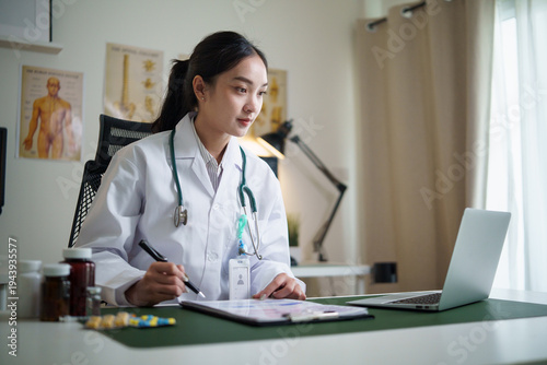 Doctor reviewing medical records and treatment plan in bright examination room. Medical and healthcare assessment concept.
