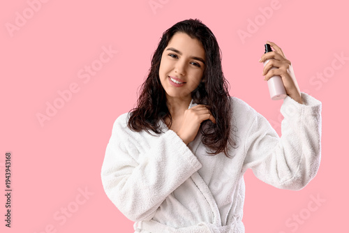 Young woman in bathrobe app...