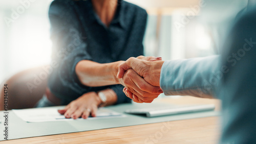 Handshake, deal and business people in office with agreement, contract or finance partnership. Meeting, welcome and financial advisor shaking hands with investor for investment negotiation at agency.