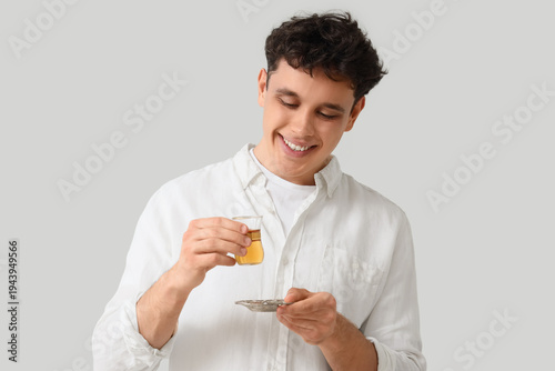Young man with Turkish tea ...