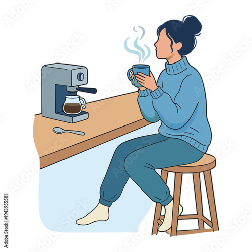 Woman sitting at counter drinking coffee from mug next to coffee maker
