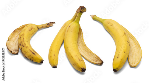 Φωτογραφία three partially peeled bananas with peels lying beside them, isolated on a transparent transparent background, showcasing fresh fruit and natural texture