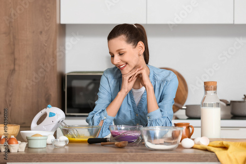 Young woman with mixer cook...