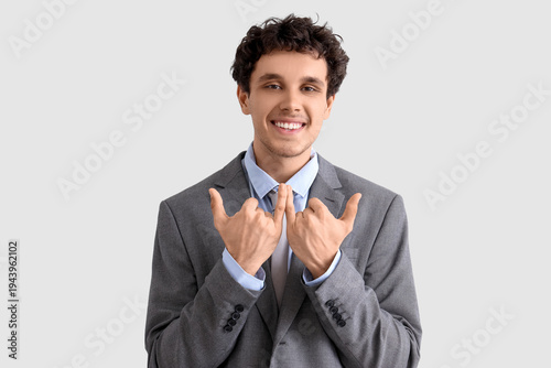 Young businessman using sig...