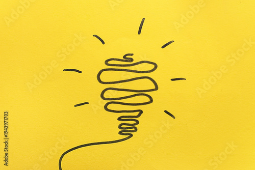 Drawn light bulb on yellow ...