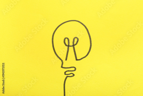 Drawn light bulb on yellow ...