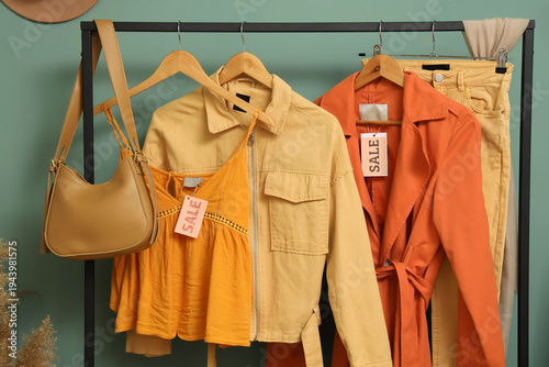 Rack with stylish clothes, ...