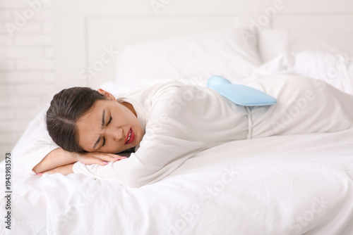 Young Asian woman warming h...