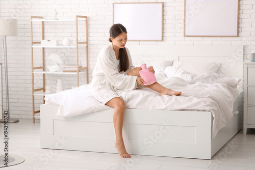 Young Asian woman warming h...