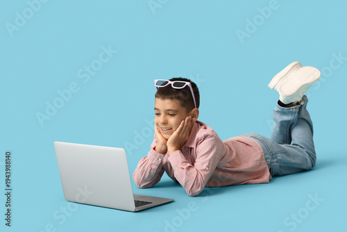 Cute happy boy with laptop ...