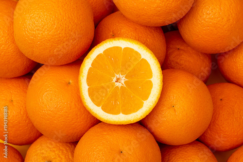 Many whole oranges pile, clementine fruits background