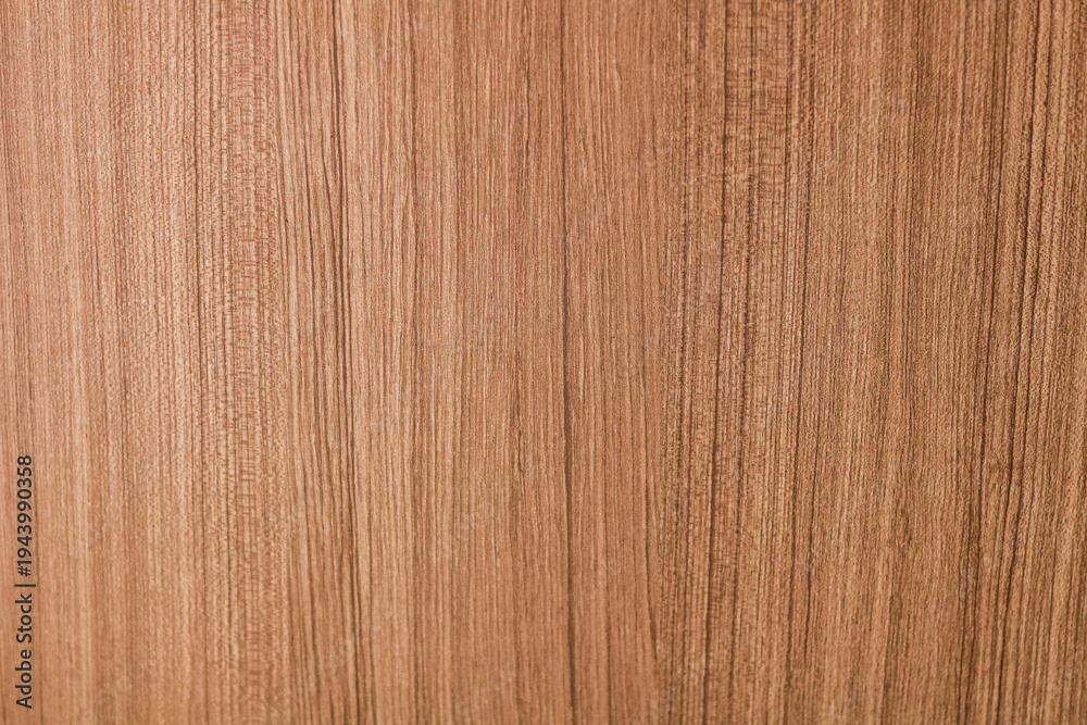 Naklejka premium A light oak or teak wood surface, highlighting a strong vertical grain pattern.