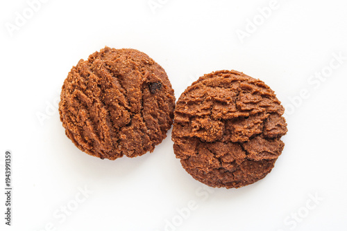 Obraz na płótnie Two chocolate cookies with a unique rippled texture isolated on white