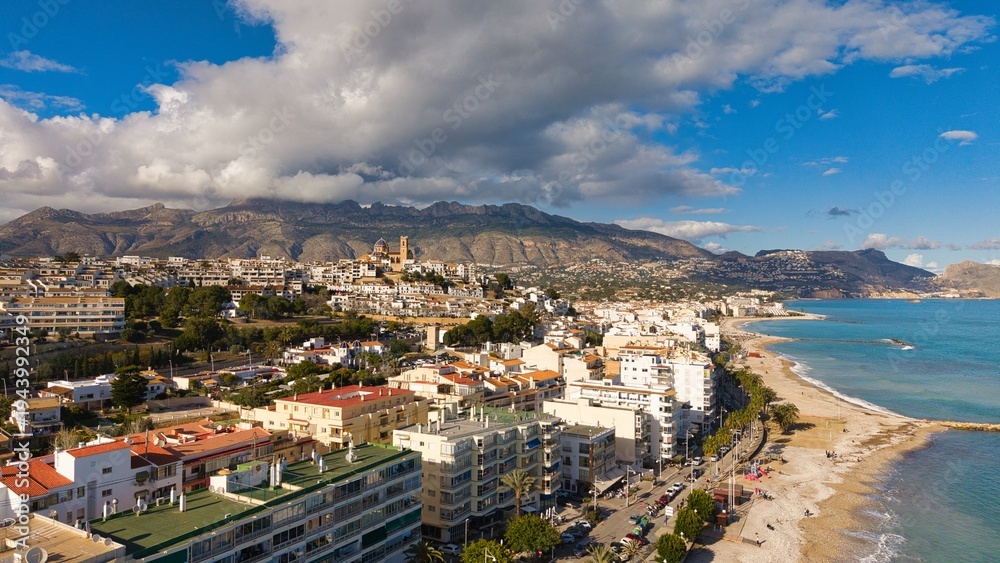 Fototapeta premium Altea coastline with church, beach and mountains under dramatic clouds, Costa Blanca, Alicante, Spain