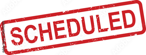A bold red rectangular distressed stamp clearly indicates the word SCHEDULED on a pristine white backdrop