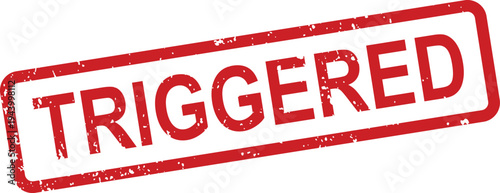 A distinct red grunge style rubber stamp emphatically displays the word TRIGGERED on a simple white surface