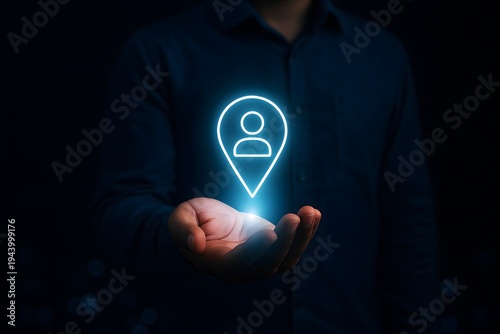 Person holds out their hand, displaying a glowing digital location pin icon with a user profile symbol, representing location-based services and user targeting.