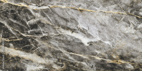 A rough natural stone wall texture features an aged grunge pattern of brown and gray rock material, creating a detailed old surface background perfect for construction or wallpaper design