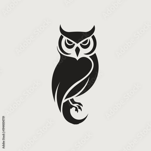 Black owl silhouette on cream background for design and illustration