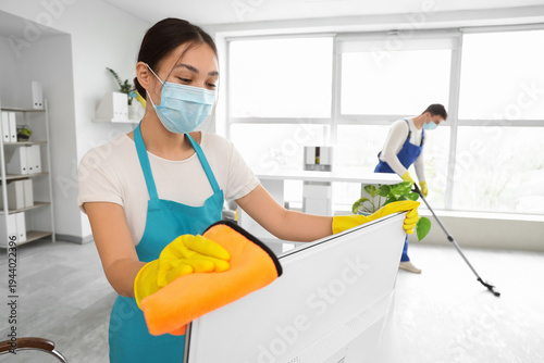 Female Asian janitor with m...