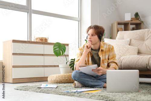 Teenage boy studying online...