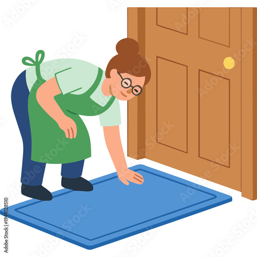 Woman cleaning floor with doormat in front of a wooden door indoors.