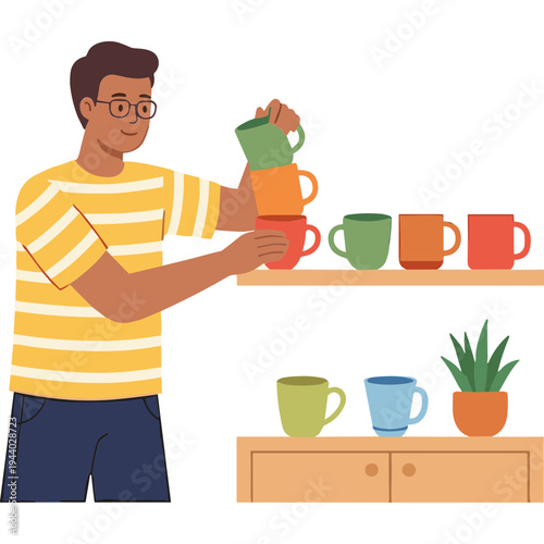 Man putting colorful cups on a shelf in a modern kitchen interior