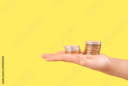 Woman holding stacks of coi...