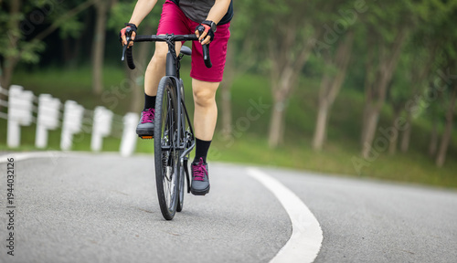 Asian woman cycling in the summer park