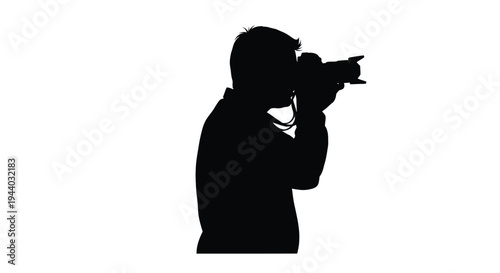 Silhouette of a photographer intently using a professional camera