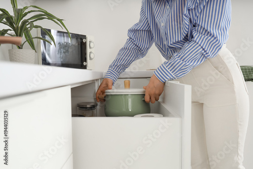 Young woman taking cooking ...