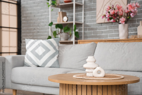 Stylish vases on table in m...