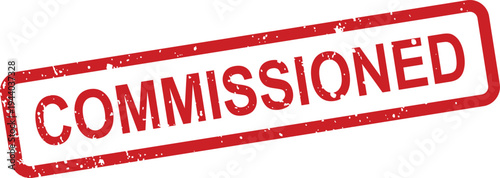 An impactful red rubber stamp with the word COMMISSIONED displaying a grunge effect against a bright white background
