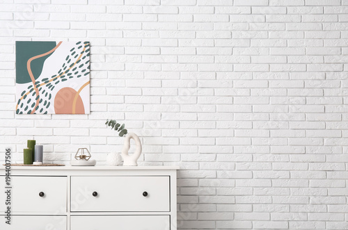 Burning candles and vase wi...