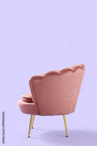 Beautiful pink armchair on lilac background, back view