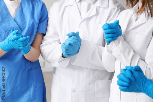 Doctors in medical gloves a...