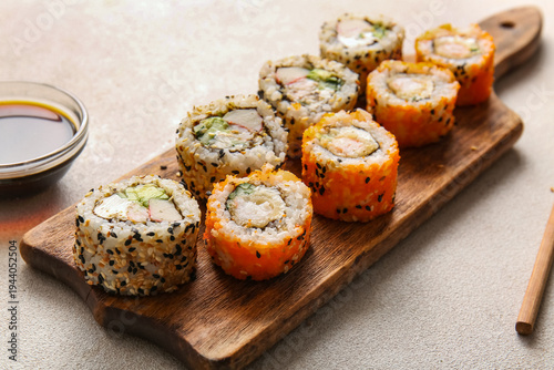 Tasty sushi rolls and soy s...