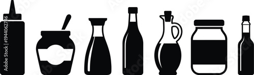 A collection of assorted bottles, jars, and containers commonly used for food condiments.