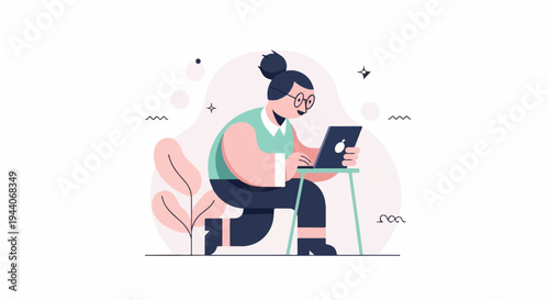 Person wearing glasses and a bun hairstyle uses a laptop on a stool
