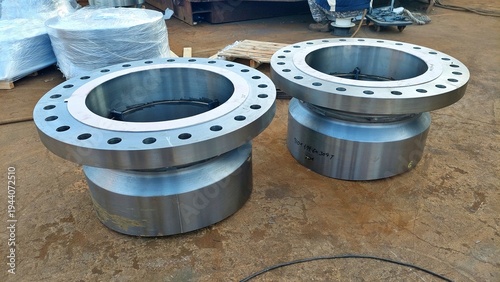 Fotografie Large machined steel flanges for industrial piping system in workshop