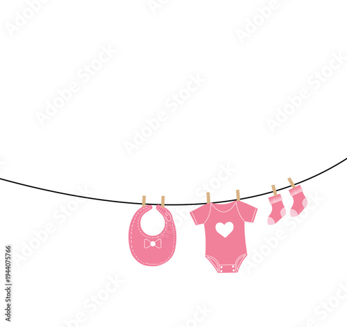 Baby clothes hanging on a line with pink bib and onesie
